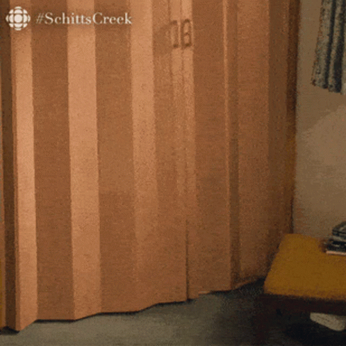 the word schitts creek that is on a wooden door