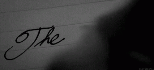 The Word The Is Written In Black Ink On A Piece Of Paper . GIF