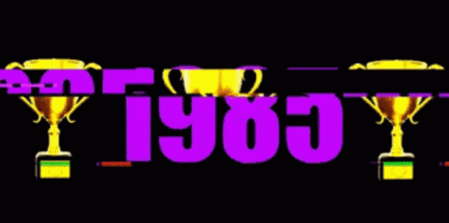The Year 1985 Is Displayed With Two Trophies In The Background GIF