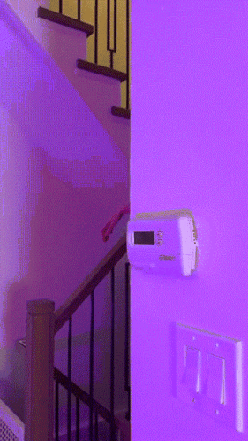 Thermostat On Purple Wall Next To Stairs GIF