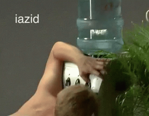 Thirsty Naked Man Drinking From Water Dispenser GIF