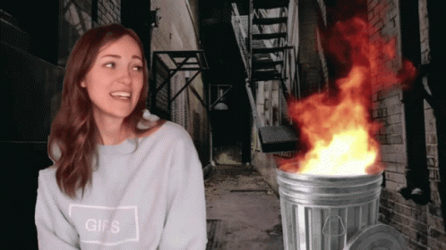 This Girl Is On Fire Beside Burning Trashcan GIF