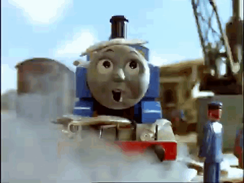 Thomas The Train Is Making A Surprised Face While A Man Stands Next To It . GIF