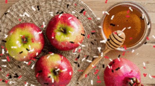 Three Apples And A Bowl Of Honey Are On A Wooden Table GIF