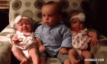 Three Babies Are Sitting Next To Each Other On A Couch And One Of Them Is Crying . GIF