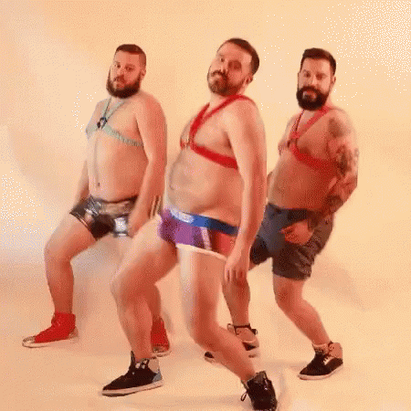 Three Bearded Men Are Dancing Together In Their Underwear And Harnesses . GIF