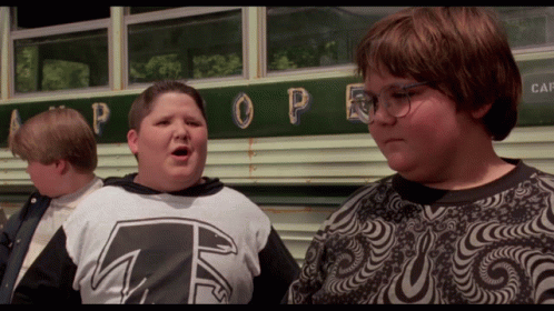 Three Boys Are Standing In Front Of A Bus With The Word Pope On It GIF