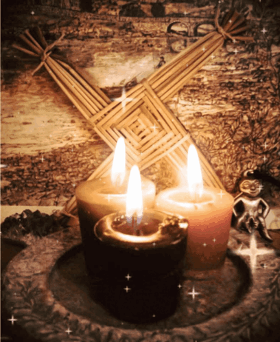 Three Candles In Front Of Straw Cross GIF