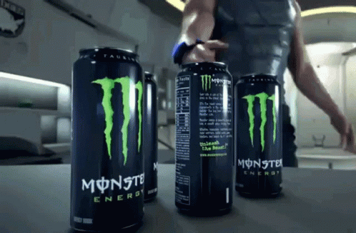 Three Cans Of Monster Energy Drink Are On A Counter GIF