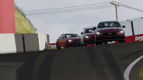 Three Cars Are Driving Down A Race Track With A Super Tires Sign In The Background GIF