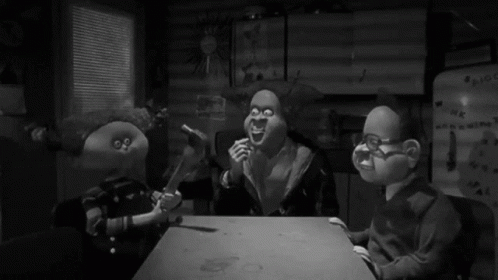 Three Cartoon Characters Are Sitting At A Table In Front Of A Refrigerator That Says ' Hk ' On It GIF