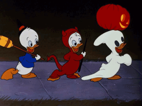 Three Cartoon Ducks Dressed In Halloween Costumes Are Walking Down A Sidewalk GIF