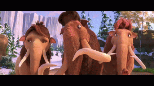 Three Cartoon Mammoths Are Standing Next To Each Other In A Snowy Landscape GIF