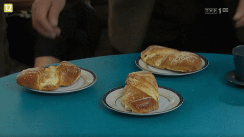 Three Croissants On Plates With TVP Logo GIF