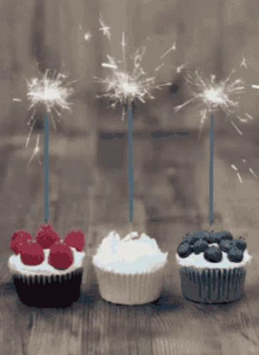 Three Cupcakes With Sparklers Lined Up