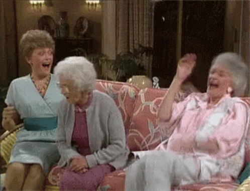 Three Elderly Women Are Sitting On A Couch Laughing And Waving Their Hands . GIF