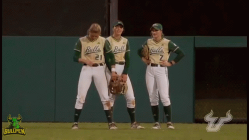 Three Female Baseball Players for the Bulls Standing on Field
