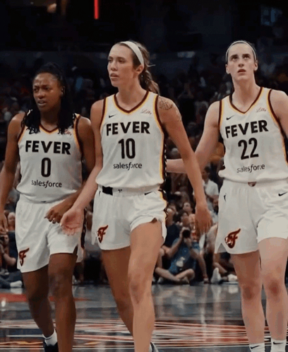 Three Female Basketball Players Wearing Fever Jerseys Walk On The Court GIF