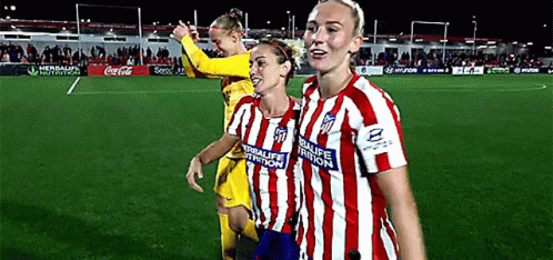 Three Female Soccer Players Wearing Red And White Striped Jerseys With Herbalife Nutrition Written On The Front GIF
