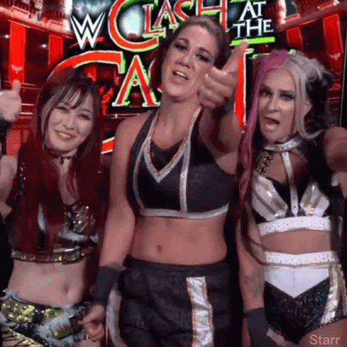 Three Female Wrestlers Posing in Front of W Clash At The A Sign