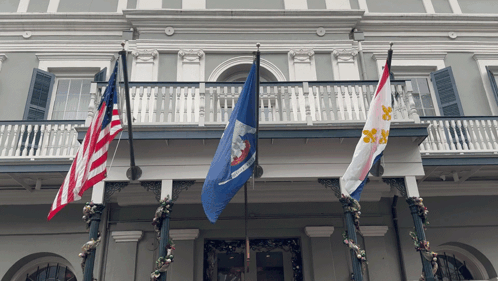 Three Flags On A Balcony Including One That Says Louisiana On It GIF
