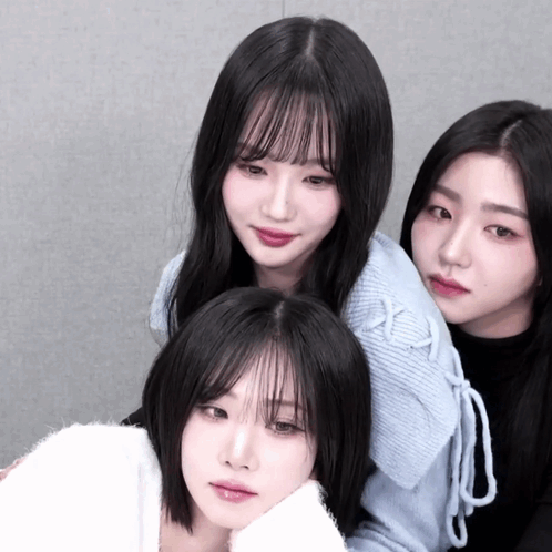 Three Girls Are Posing For A Picture And One Of Them Is Wearing A White Sweater GIF