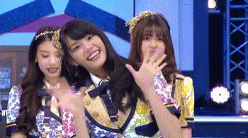 Three Girls Standing on Stage