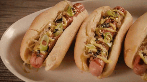 Three Hot Dogs with Onions and Mustard