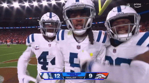 three indianapolis colts players celebrate a touchdown against broncos