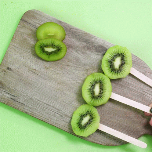 Three Kiwi Popsicle Slices on Wooden Board