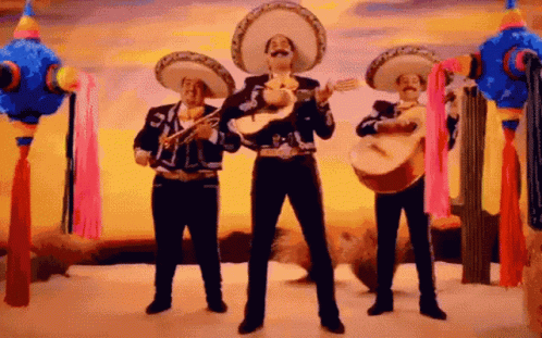 Three Mariachi Singers Playing Instruments