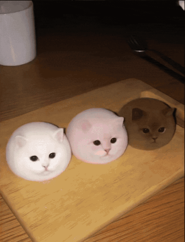Three Marshmallow Cats On Wooden Cutting Board