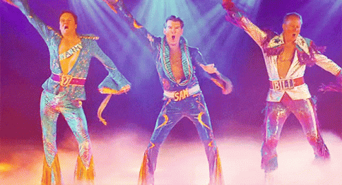 Three Men Are Dancing On A Stage And One Of Them Has The Word Sam On His Chest GIF