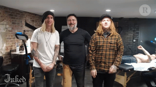 Three Men Are Posing For A Picture In A Room With The Word Inked On The Bottom GIF