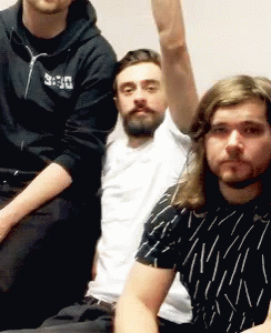 Three Men Are Posing For A Picture With One Wearing A Black Hoodie With The Word Deus On It GIF
