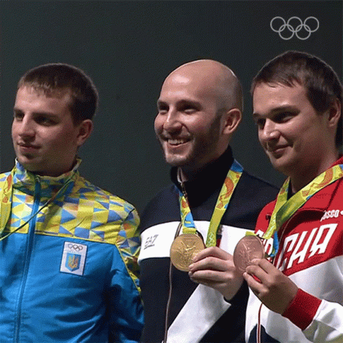 Three Men Are Posing For A Picture With One Wearing A Jacket That Says Ea7 On It GIF