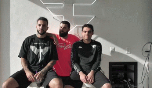 Three Men Are Posing For A Picture With One Wearing A T-Shirt That Says " Fate Clan " GIF