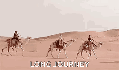 three men are riding camels through the desert .