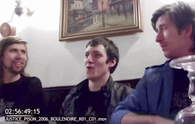 Three Men Are Sitting In Front Of A Clock That Says 02:56:49 15 GIF