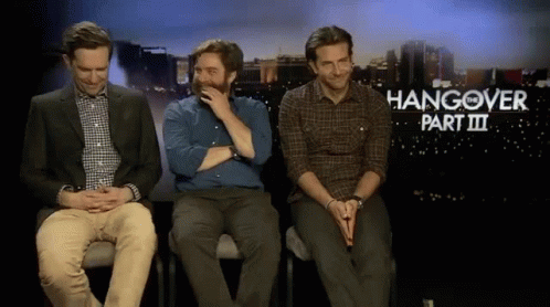 Three Men Are Sitting In Front Of A Hangover Part Iii Sign GIF