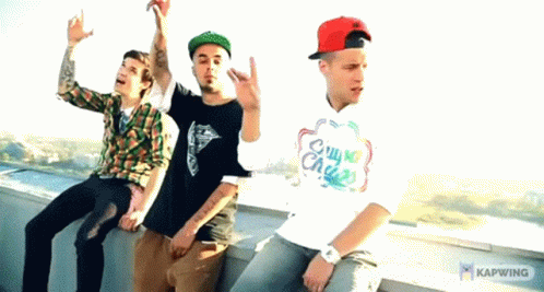 Three Men Are Sitting On A Ledge With One Wearing A Shirt That Says Chill My Chase GIF