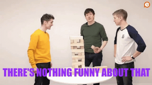 Three Men Are Standing Around A Table With A Stack Of Wooden Blocks On Top Of It . GIF
