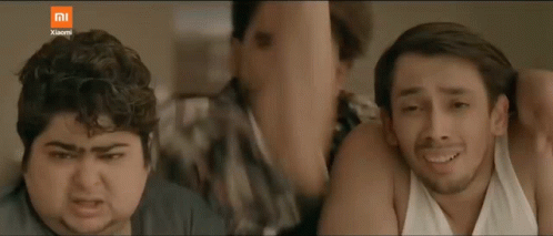 Three Men Are Standing Next To Each Other And One Is Holding A Cell Phone With The Xiaomi Logo On The Bottom GIF