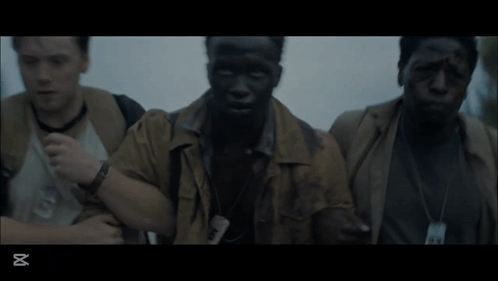 Three Men Are Standing Next To Each Other In A Dark Room With The Letters Xt On The Bottom GIF