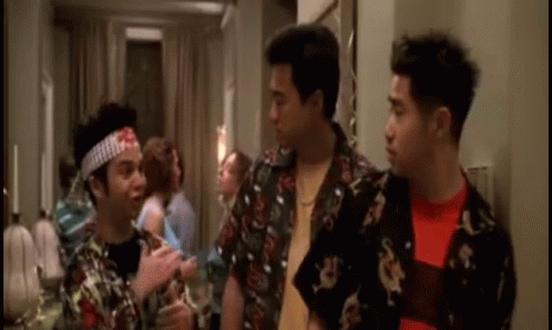 Three Men Are Standing Next To Each Other In A Room And One Of Them Has A Bandana On His Head . GIF