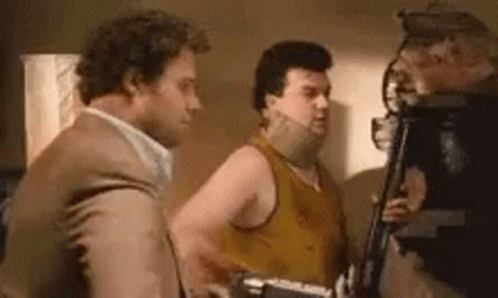 Three Men Are Standing Next To Each Other In A Room And Talking To Each Other . GIF