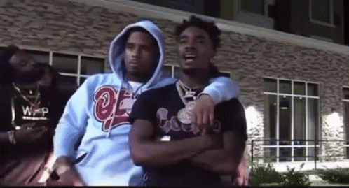 Three Men Are Standing Next To Each Other In Front Of A Building . GIF