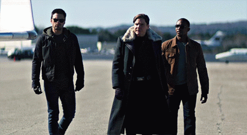 Three Men Are Walking On A Runway And One Has A Fur Collar GIF
