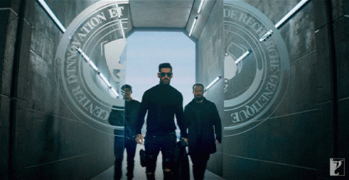 Three Men Are Walking Through A Tunnel That Says Innovation Et De Recevoir GIF