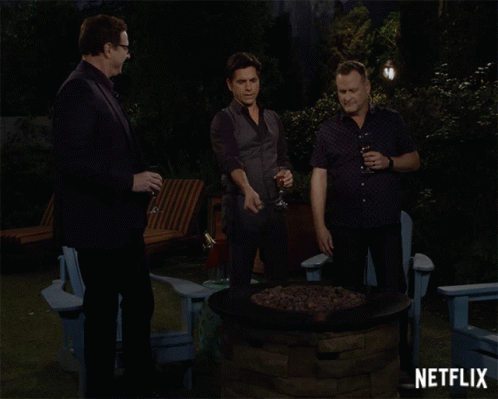 Three Men Around Fire Pit With Netflix GIF